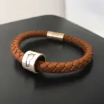 a brown leather bracelet with a silver ring